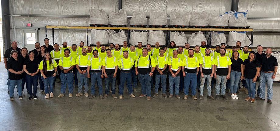 A photo inside showing a group of employees posing for the camera.